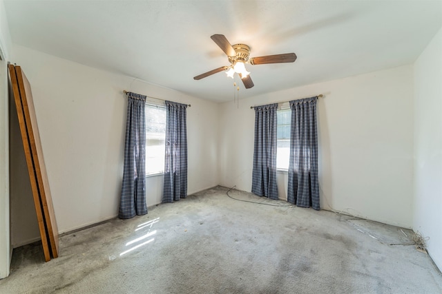 spare room with light colored carpet and ceiling fan