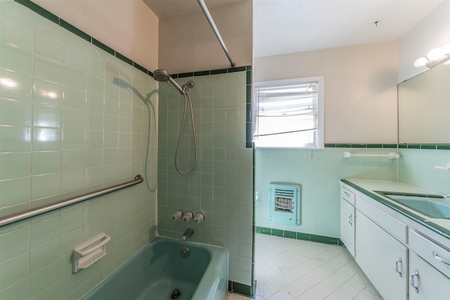 bathroom with tiled shower / bath, vanity, heating unit, and tile walls