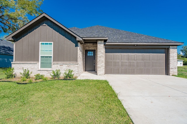 view of front facade with a garage and a front lawn