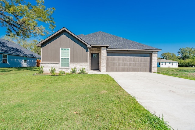 view of front of house with a front lawn and a garage