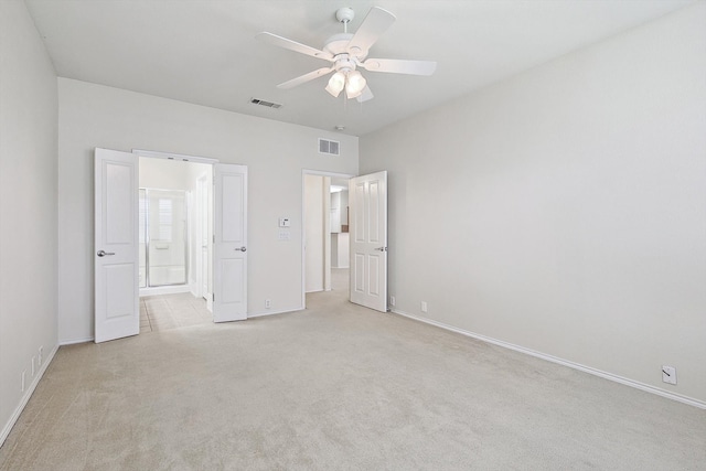 unfurnished bedroom featuring light carpet and ceiling fan