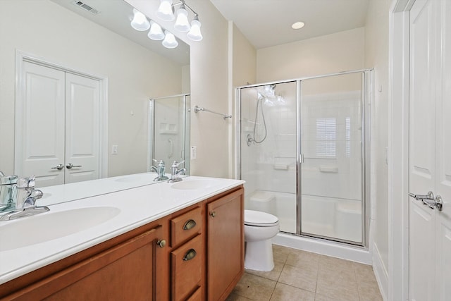 bathroom with vanity, toilet, an enclosed shower, and tile patterned floors