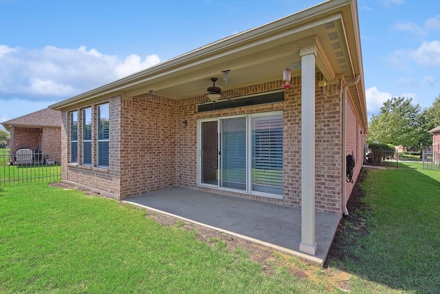 rear view of house featuring a yard, a patio area, and ceiling fan