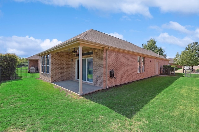 view of side of home featuring a patio and a yard