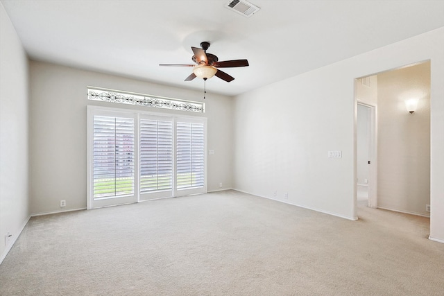 unfurnished room featuring light carpet and ceiling fan