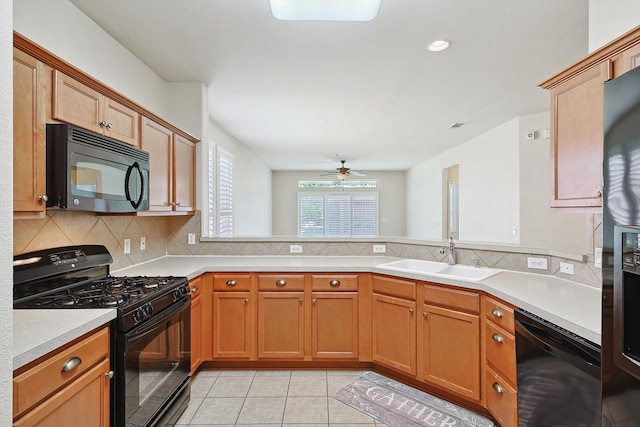 kitchen featuring kitchen peninsula, black appliances, sink, and ceiling fan