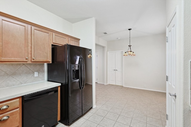 kitchen with a chandelier, pendant lighting, decorative backsplash, black appliances, and light tile patterned floors