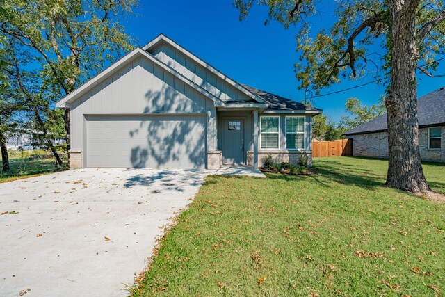 view of front facade with a garage and a front lawn