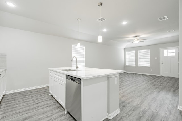 kitchen featuring white cabinets, pendant lighting, an island with sink, dishwasher, and light hardwood / wood-style floors