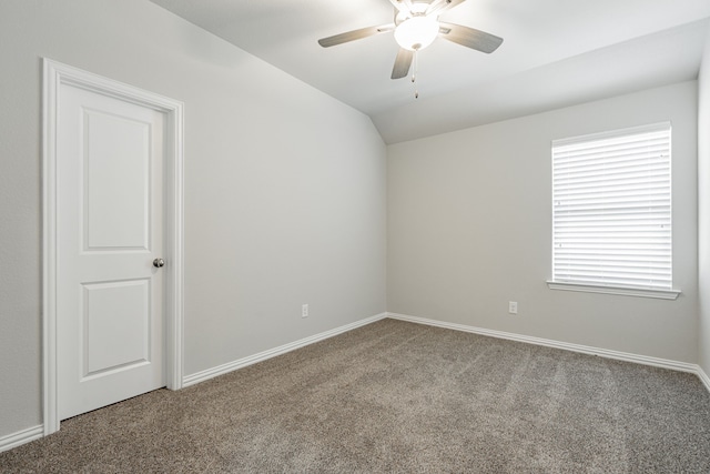 spare room with carpet floors, lofted ceiling, and ceiling fan