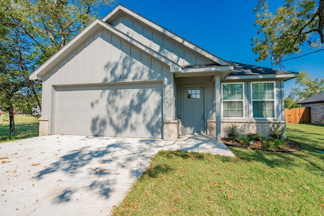 view of front of home featuring a garage and a front lawn