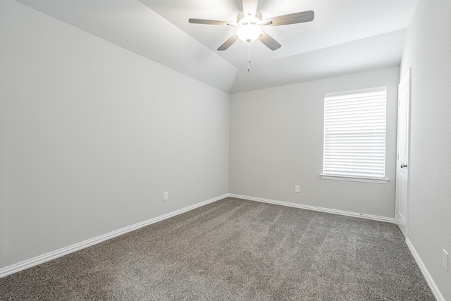 spare room featuring lofted ceiling, carpet flooring, and ceiling fan