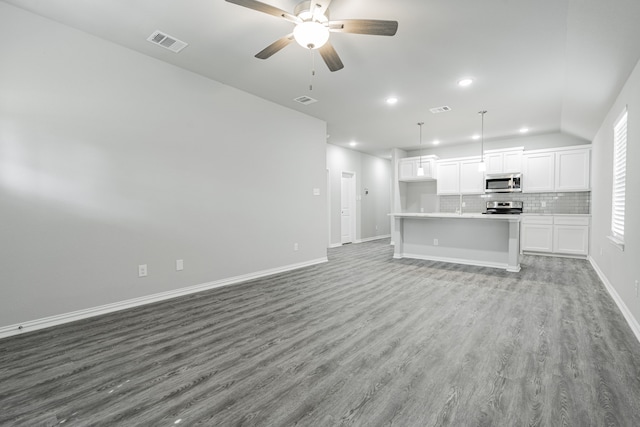 unfurnished living room with ceiling fan, vaulted ceiling, and light hardwood / wood-style floors