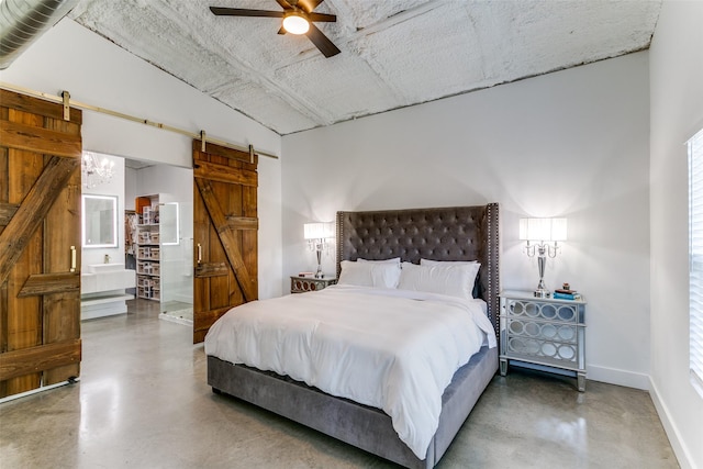 bedroom featuring finished concrete floors, baseboards, a barn door, and a ceiling fan