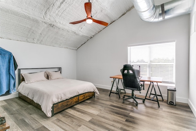 bedroom with baseboards, wood finished floors, a ceiling fan, and vaulted ceiling