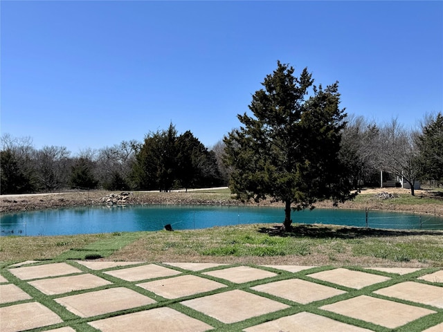 view of swimming pool featuring a water view