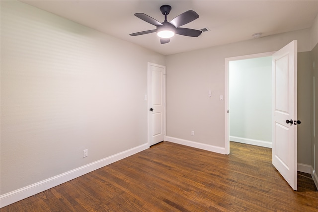 unfurnished bedroom featuring dark wood-type flooring and ceiling fan