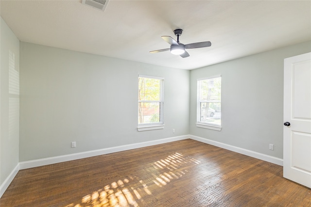 empty room with ceiling fan and dark wood-type flooring