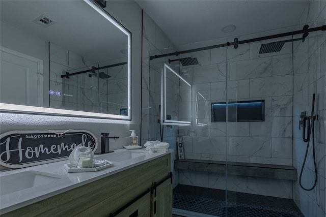 bathroom with a shower with shower door and vanity