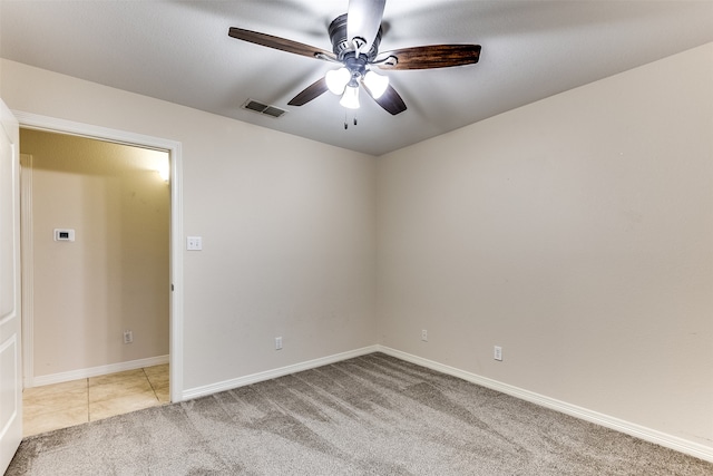 empty room featuring light carpet and ceiling fan