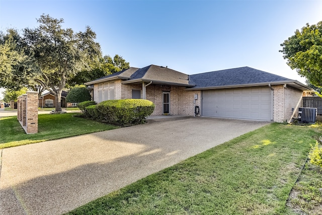 view of front facade with a front lawn, central air condition unit, and a garage