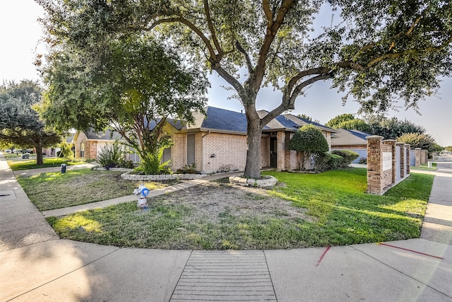 ranch-style home featuring a front yard