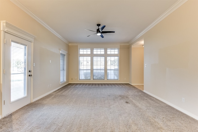 carpeted empty room with ceiling fan and crown molding