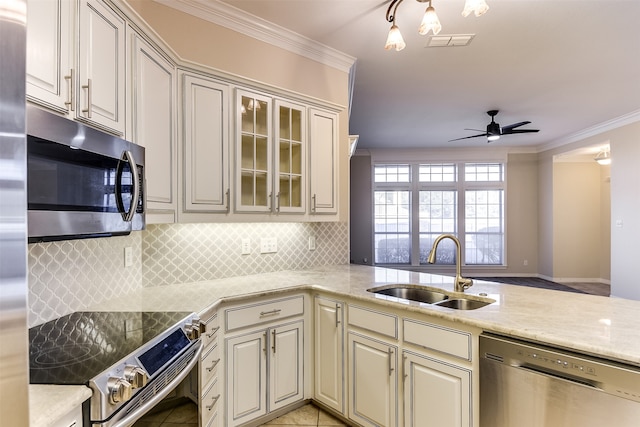 kitchen with ornamental molding, stainless steel appliances, sink, and kitchen peninsula