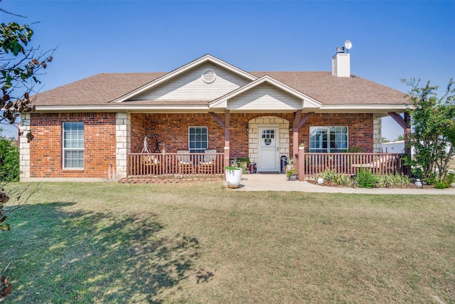 single story home featuring covered porch and a front lawn