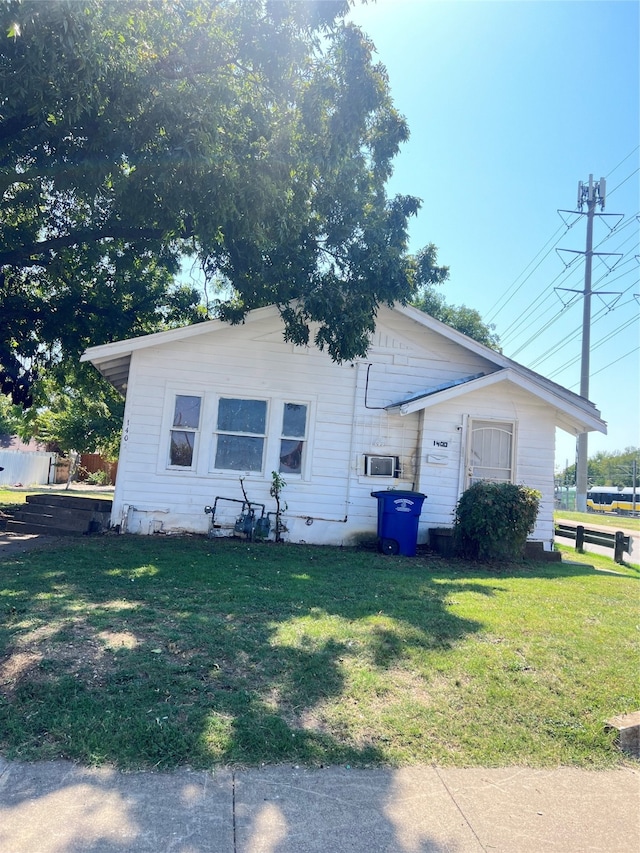 view of side of home featuring a yard