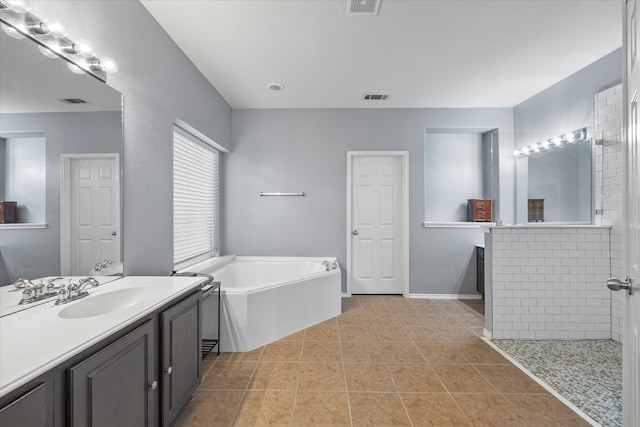 bathroom featuring vanity, shower with separate bathtub, and tile patterned floors