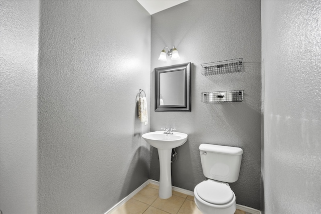 bathroom featuring tile patterned flooring and toilet