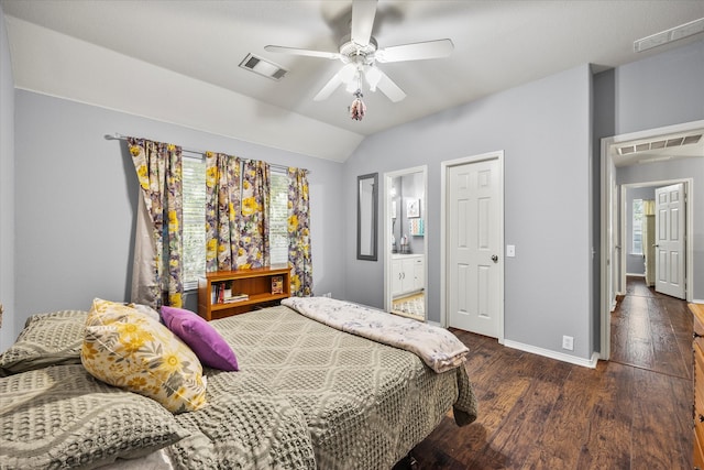 bedroom with ceiling fan, lofted ceiling, ensuite bath, and dark hardwood / wood-style flooring