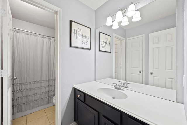 bathroom featuring tile patterned floors, vanity, and toilet