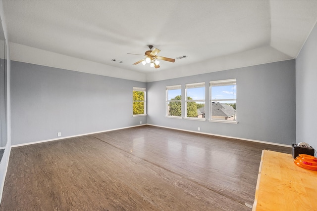 spare room featuring ceiling fan, vaulted ceiling, and dark hardwood / wood-style floors