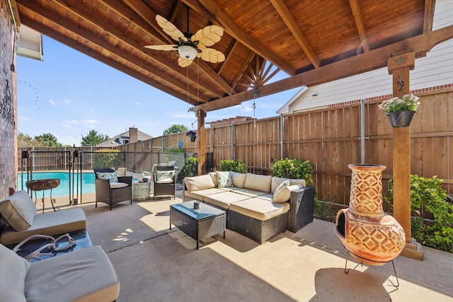 view of patio with outdoor lounge area, ceiling fan, and a fenced in pool