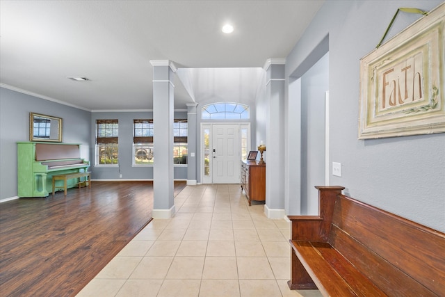 entryway featuring crown molding and light hardwood / wood-style flooring