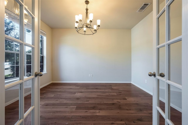 1310 Gold Coast Dr, Rockwall, TX 75087 - empty room with visible vents, french doors, a notable chandelier, and dark wood-style floors