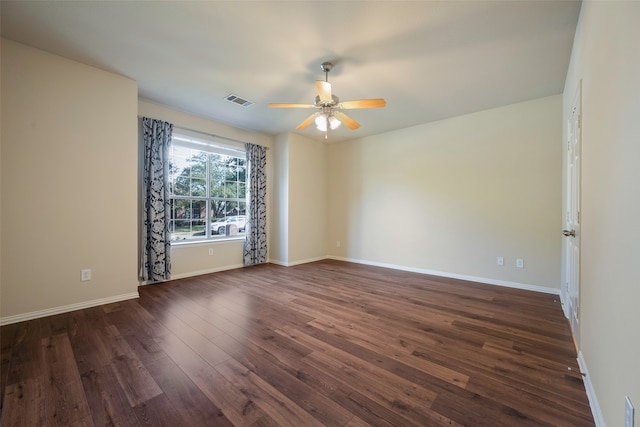 spare room with dark hardwood / wood-style floors and ceiling fan