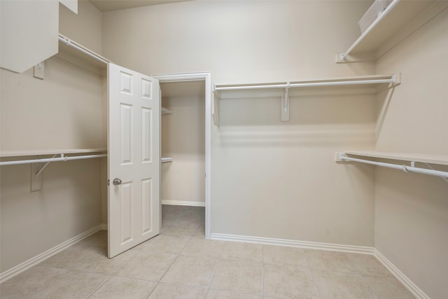 spacious closet featuring light tile patterned flooring