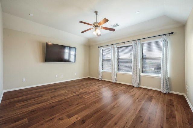 empty room with lofted ceiling, dark wood-type flooring, and ceiling fan