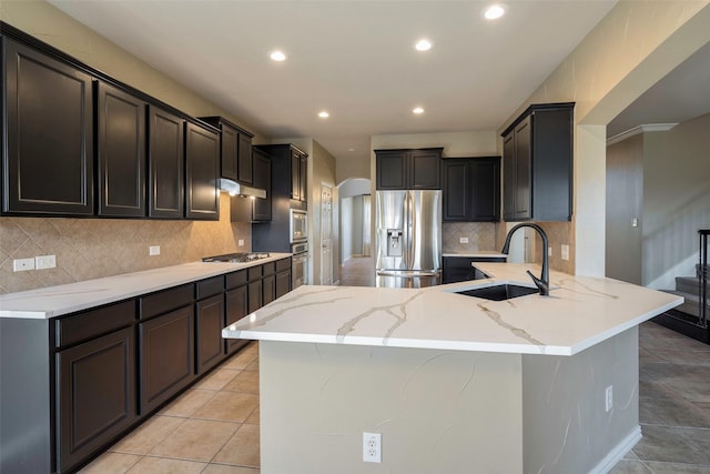1310 Gold Coast Dr, Rockwall, TX 75087 - kitchen with recessed lighting, light stone countertops, a sink, and stainless steel appliances