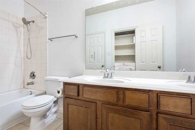 full bathroom featuring vanity, tiled shower / bath combo, toilet, and tile patterned flooring