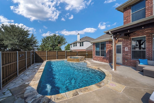 view of swimming pool with a patio and an in ground hot tub