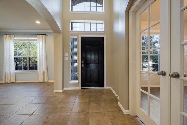 tiled foyer entrance featuring french doors