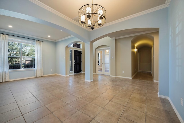 1310 Gold Coast Dr, Rockwall, TX 75087 - unfurnished room with arched walkways, an inviting chandelier, ornamental molding, baseboards, and light tile patterned flooring