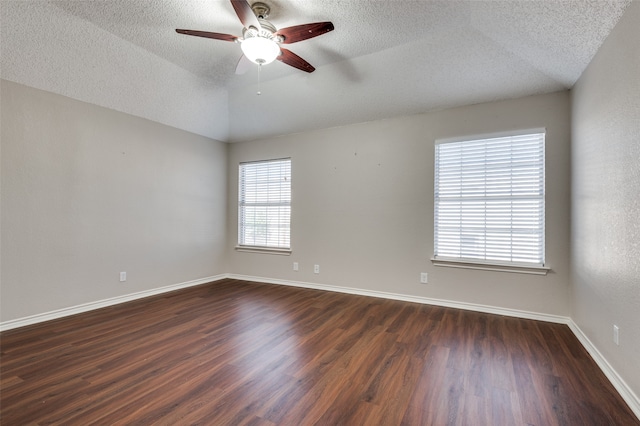 spare room featuring a textured ceiling, dark hardwood / wood-style floors, ceiling fan, and lofted ceiling