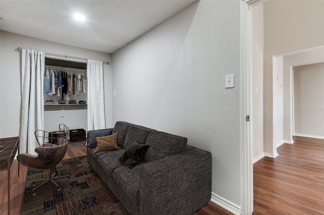 living room with hardwood / wood-style flooring and a textured ceiling