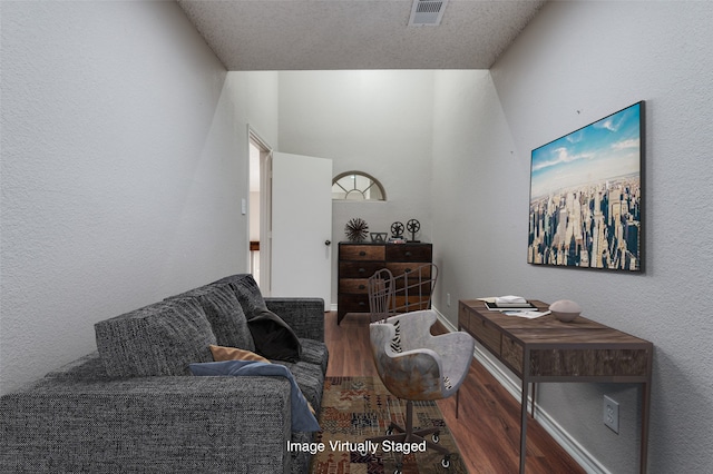 living room featuring hardwood / wood-style flooring and a textured ceiling