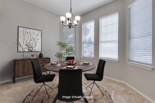 tiled dining area with a wealth of natural light and a chandelier